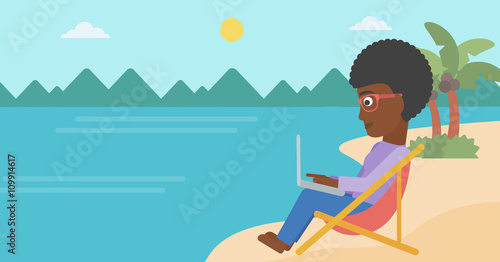 Business woman sitting in chaise lounge with laptop.