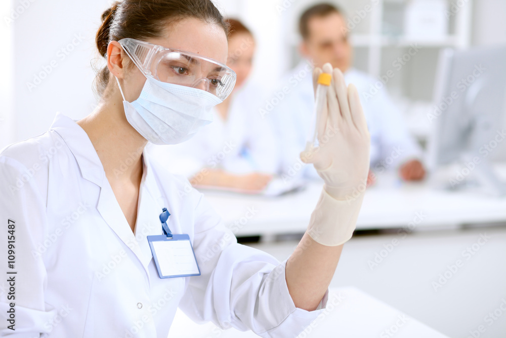 Scientific research team with clear solution in laboratory Scientific research team with clear solution in laboratory