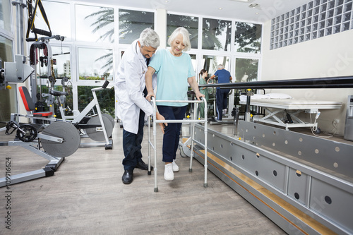 Φωτογραφία Male Physiotherapist Assisting Senior Female Patient With Walker