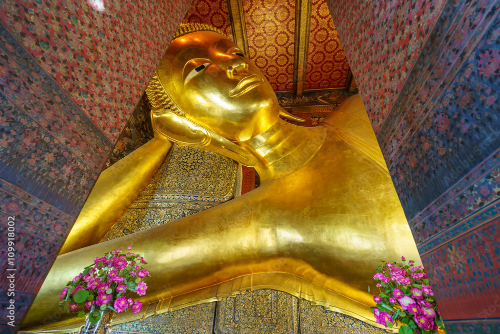 View of the Reclining Buddha gold statue inside famous Wat Pho temple. Wat Pho is a Buddhist temple complex founded in 16th century