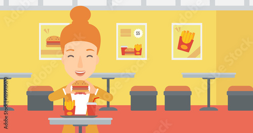 Woman eating hamburger. 