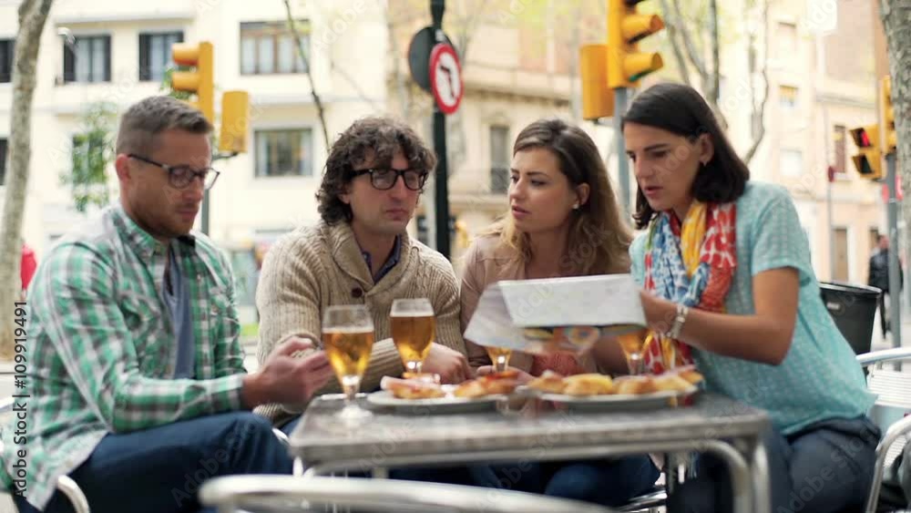 Group of friends looking on documents while sitting in the cafe
Group of friends looking on documents while sitting in the cafe
