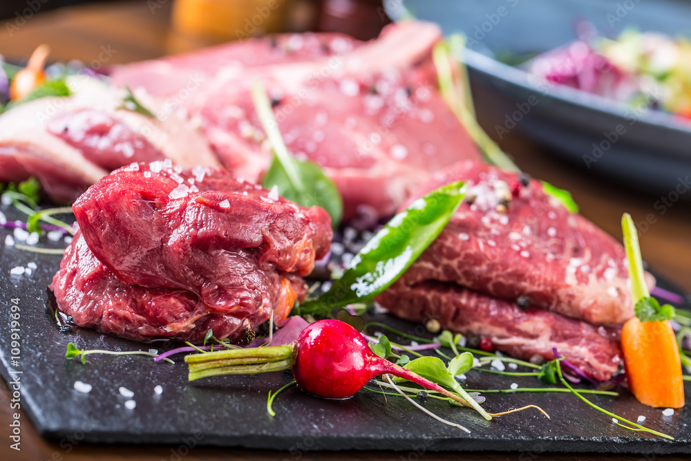 Steak.Beef steak.Meat.Portioned meat.Raw fresh meat.Sirloin steak.T-Bone steak. Flank steak. Duck breast. Vegetable decoration. Portioned meat prepared for processing in a restaurant or hotel kitchen. Steak.Beef steak.Meat.Portioned meat.Raw fresh meat.Sirloin steak.T-Bone steak. Flank steak. Duck breast. Vegetable decoration. Portioned meat prepared for processing in a restaurant or hotel kitchen.