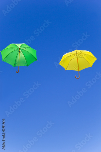 Colorful umbrellas in the sky on blue background