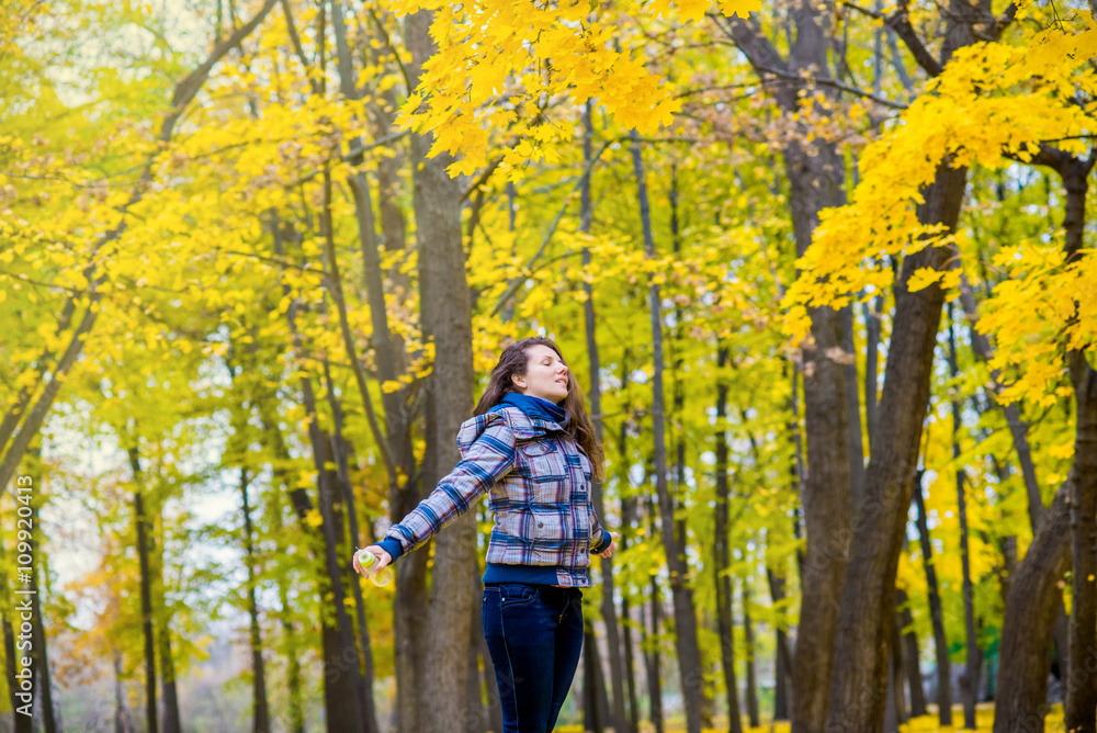 girl spinning in autumn park fun girl spinning in autumn park fun