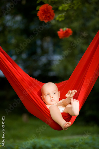 Newborn baby boy relaxing in a hammock photo