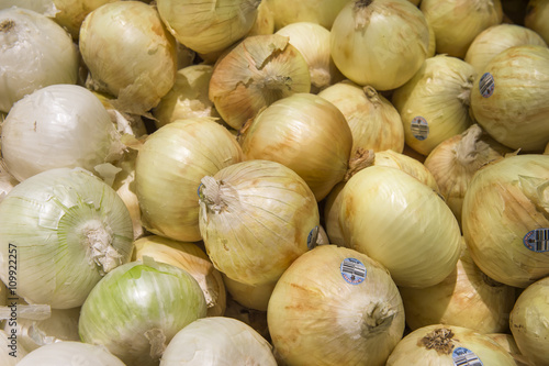 yellow onions crop from market shelves real with flaws and bruis