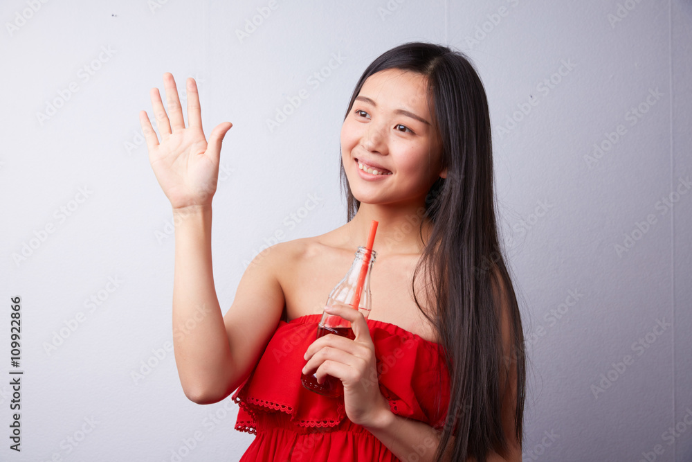 Chinese woman drinking carbonated drink through a straw Chinese woman drinking carbonated drink through a straw