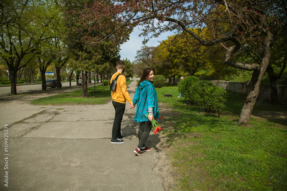 Fototapeta premium Young happy attractive couple walking together , outdoors