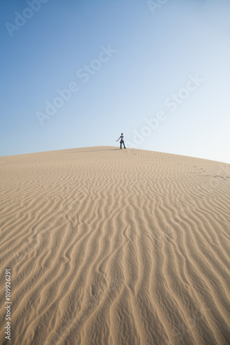 woman on top of the dune