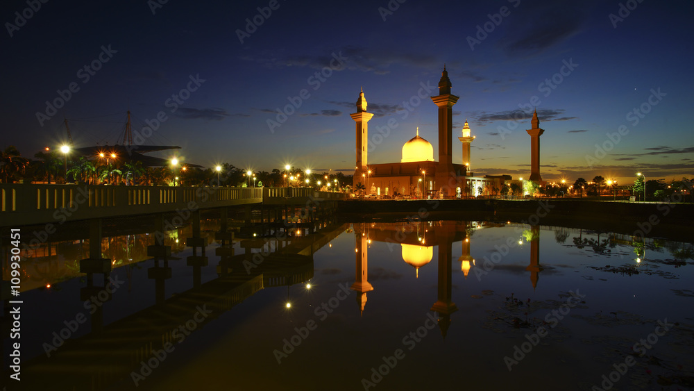 Reflection of a modern beautiful mosque during blue hour sunrise