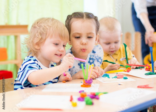 happy kids doing arts and crafts in day care centre