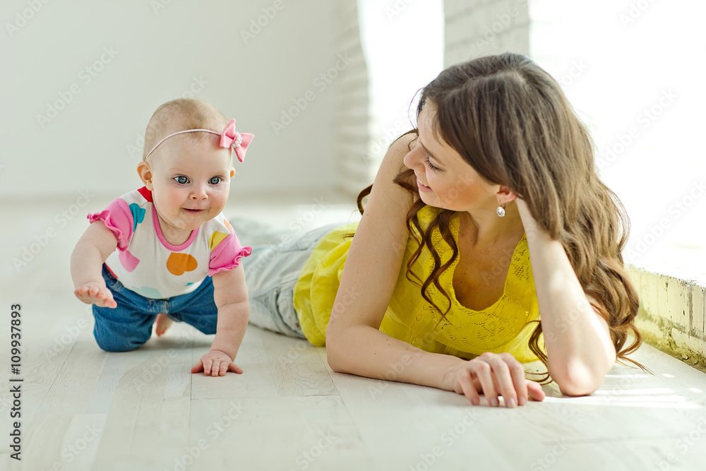 Mother play with baby in studio Mother play with baby in studio
