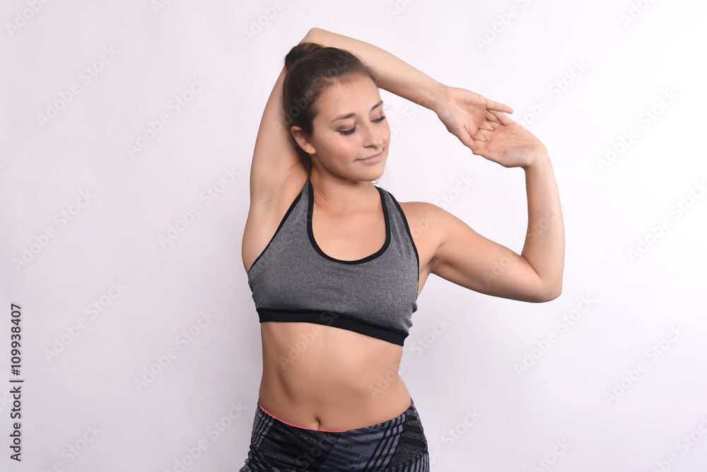 Fototapeta premium Athlete young woman doing exercise.