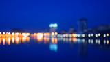 Metropolis never sleep. Blurred shot of riverfront with colorful reflections. A lot of space for text.