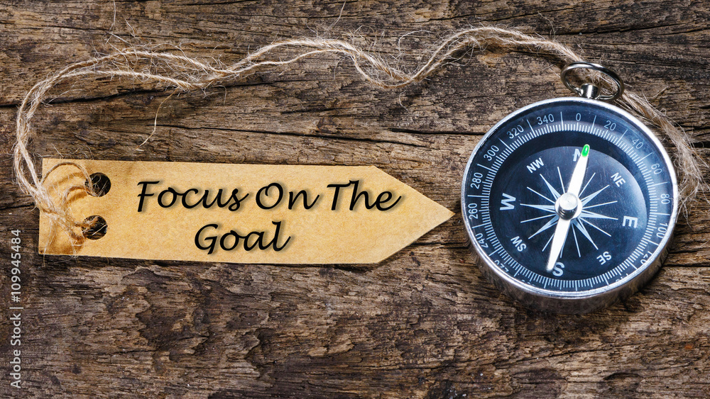 Focus on the goal - Motivation handwriting on label with compass Focus on the goal - Motivation handwriting on label with compass