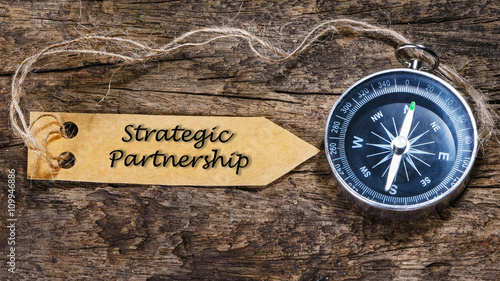 Strategic partnership - business tips handwriting on label with