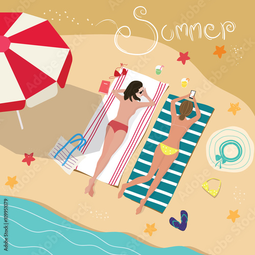 Girls lying on sandy beach