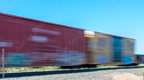 Passing train with motion blur boxcars