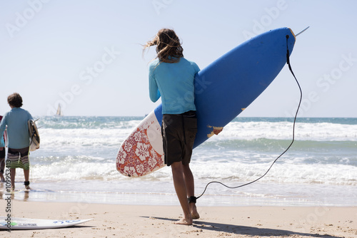 surfer carries board