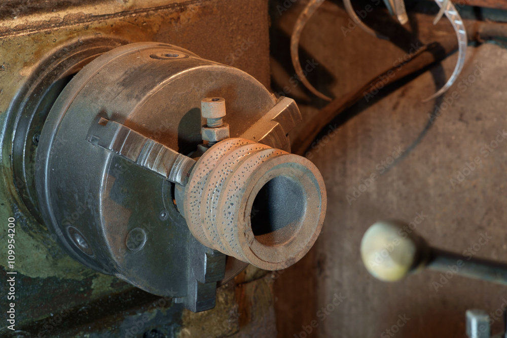 Lathe machine / Old and dirty lathe machine under tungsten light. Lathe machine / Old and dirty lathe machine under tungsten light.