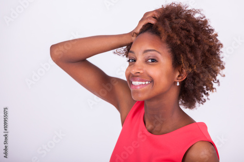 Photos Young African American woman holding her frizzy afro hair - Blac