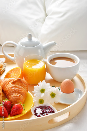 Breakfast tray in bed in hotel room