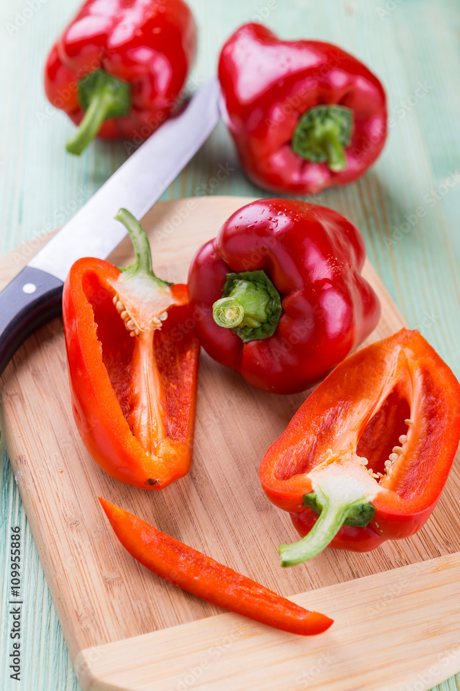 Fresh organic bell peppers on a wooden board
