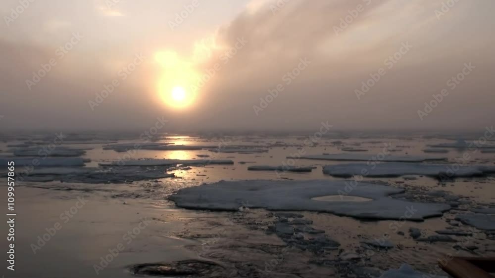 Sunset in the ocean among the icebergs and ice in the Arctic. Fantastic wonderful amazing video grenland nature iceland. Lovely shooting the life of nature, seaside and mountains. Global warming. Sunset in the ocean among the icebergs and ice in the Arctic. Fantastic wonderful amazing video grenland nature iceland. Lovely shooting the life of nature, seaside and mountains. Global warming.