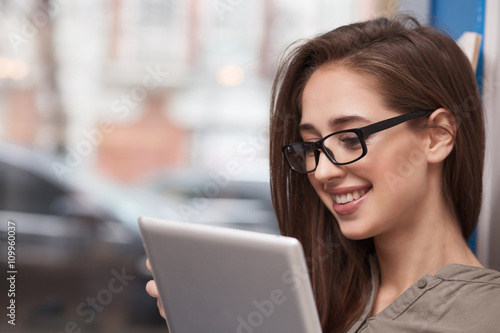 Beautiful young girl is using modern technology