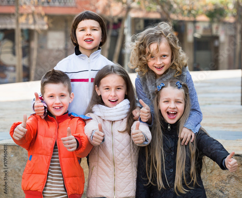 Group of children posing at urban street © JackF