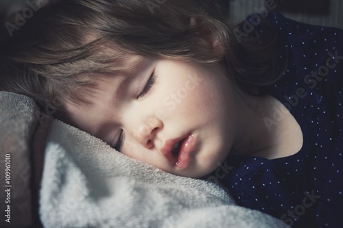 Toddler girl is peacefully sleeping 