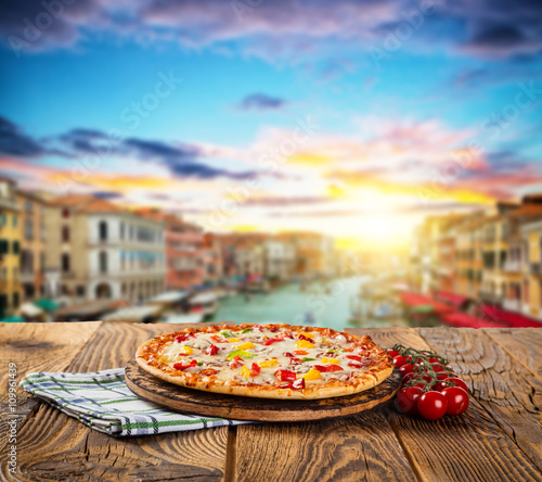 Rustic pizza with old city Italy background