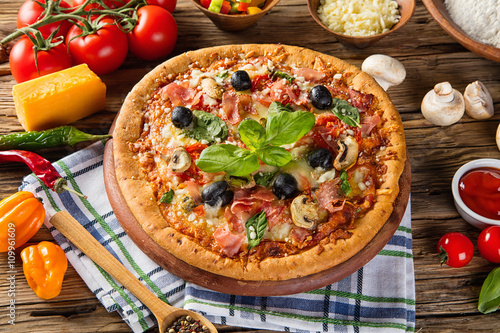 Rustic pizza with ingredients, top view