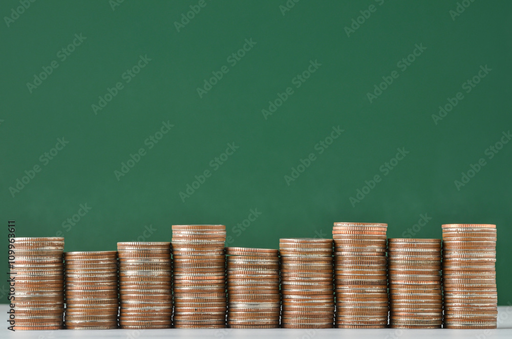 stack of coins on green background stack of coins on green background