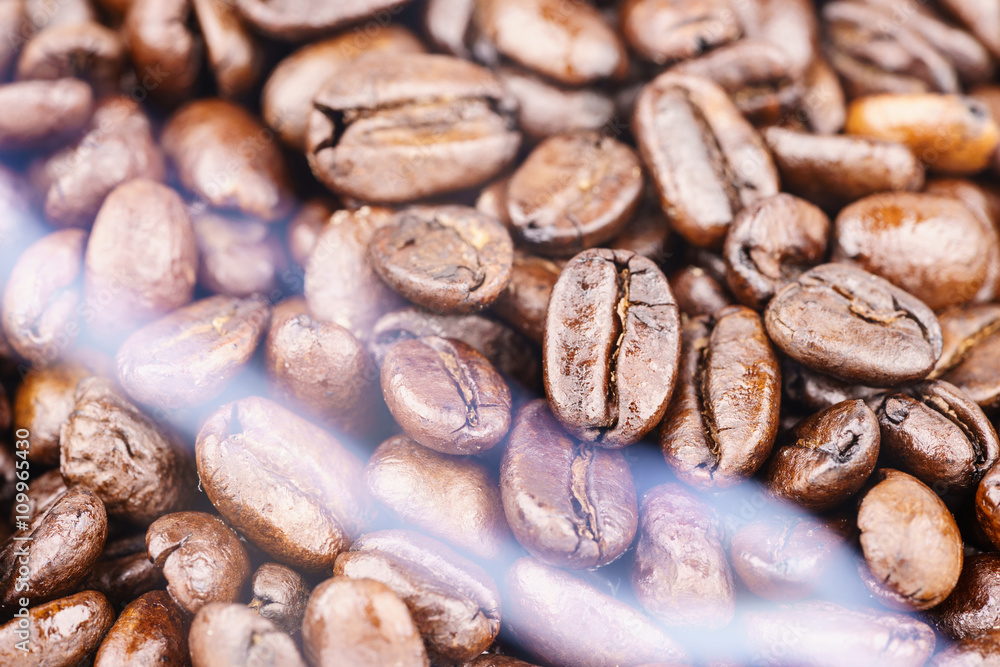 Fototapeta premium Coffee beans from the roaster with the smoke