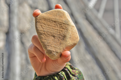 stone in a child's hand