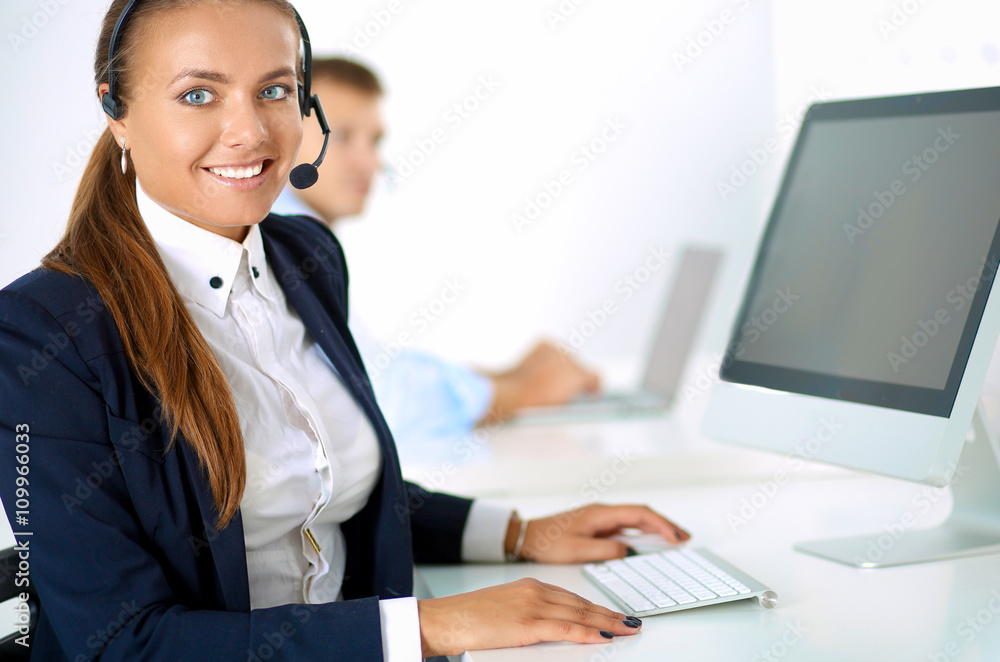 Happy female wearing headset and sitting on the desk Happy female wearing headset and sitting on the desk