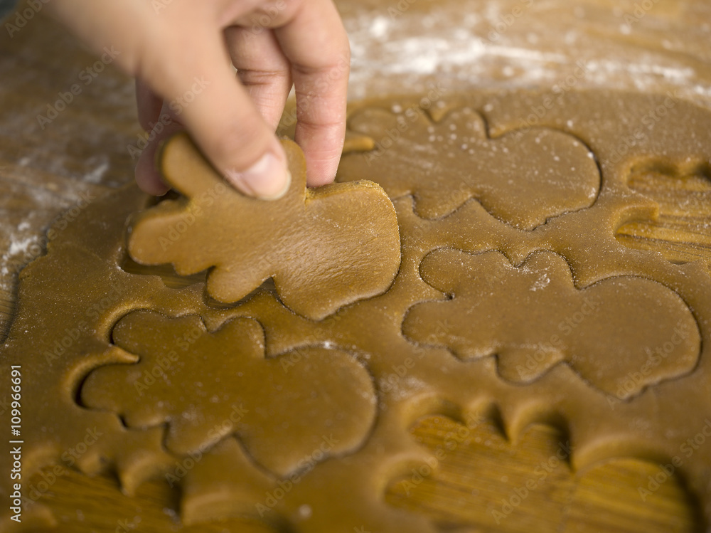 close-up of hand preparing gingerbread cookies close-up of hand preparing gingerbread cookies