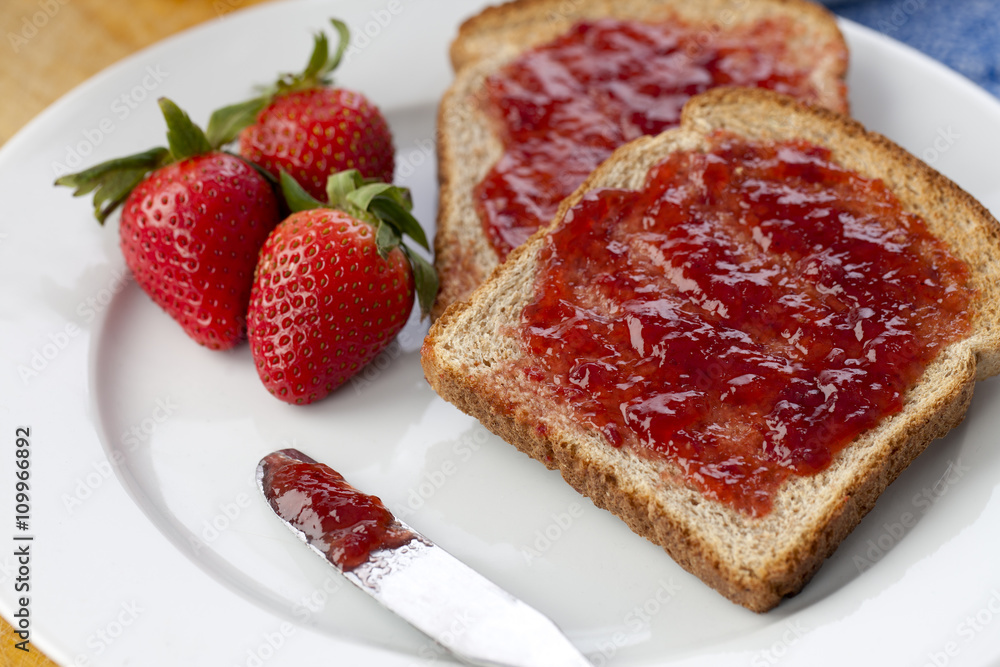 slice of bread with strawberry fruit and jam