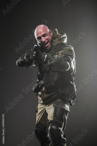 soldier man hold Machine gun on a dark background