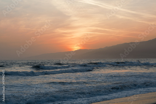 The Pacific ocean during sunset. Landscape with blue sea  the mountains and the dusk sky  the USA  Santa Monica. 