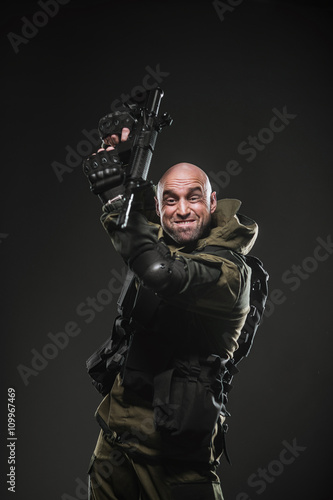 soldier man hold Machine gun on a  dark background