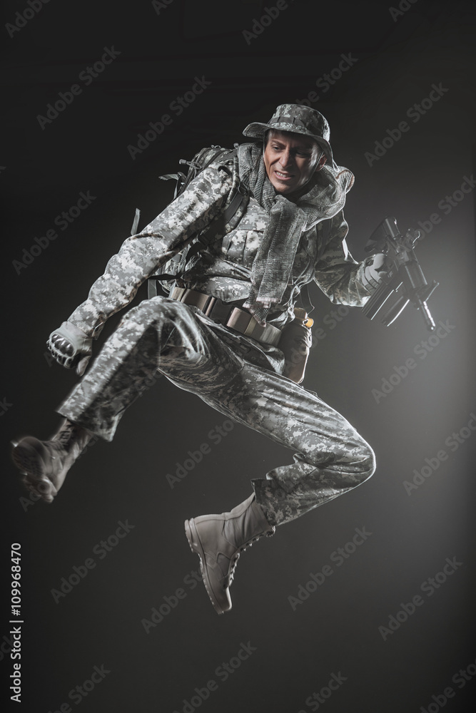 Fototapeta premium Special forces soldier man with Machine gun on a dark background