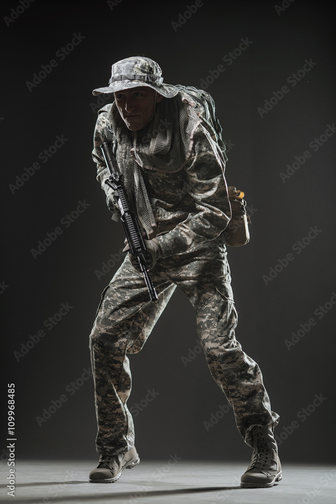 Special forces soldier man with Machine gun on a  dark background