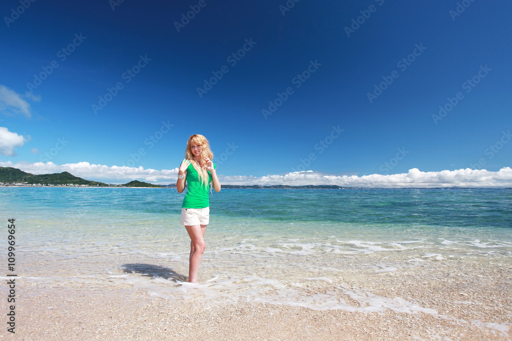 海辺で遊ぶ笑顔の女性
