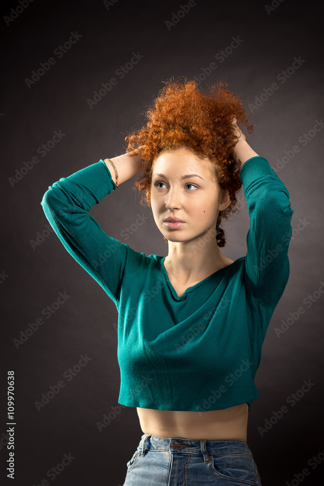 portrait of red-haired girl corrects her hair portrait of red-haired girl corrects her hair