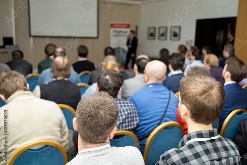 The audience listens to the acting in a conference hall