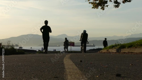 Silhouettes bicycles ocean mountains Vancouver