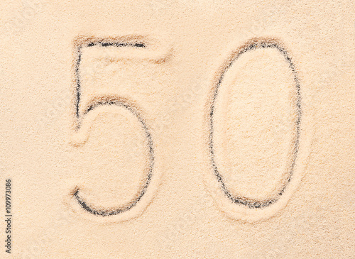 50 number written on beach sand
